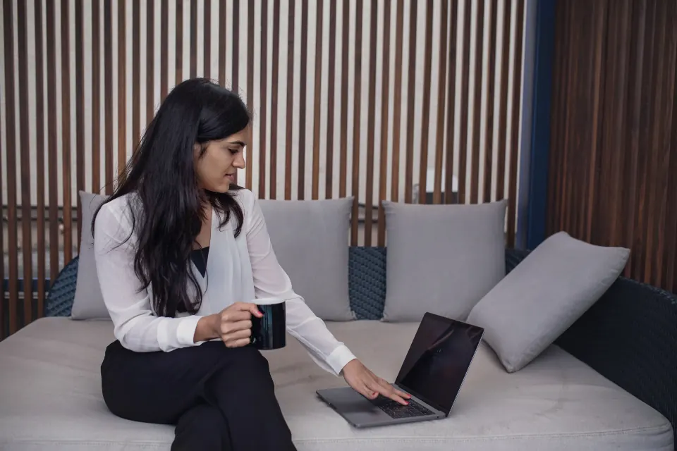 A woman studying a course on her laptop at home