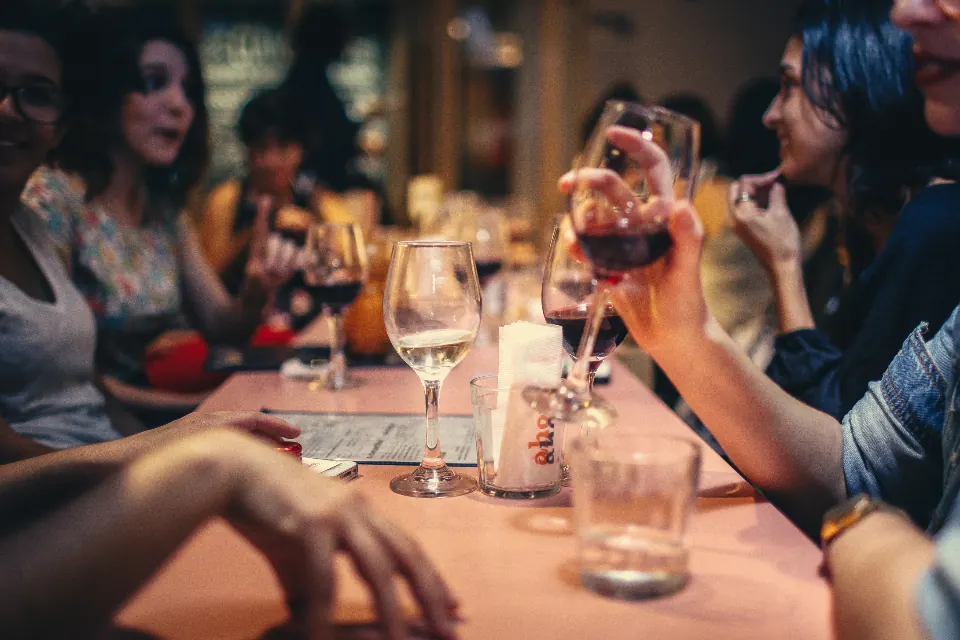 Friends sharing drinks at a restaurant table